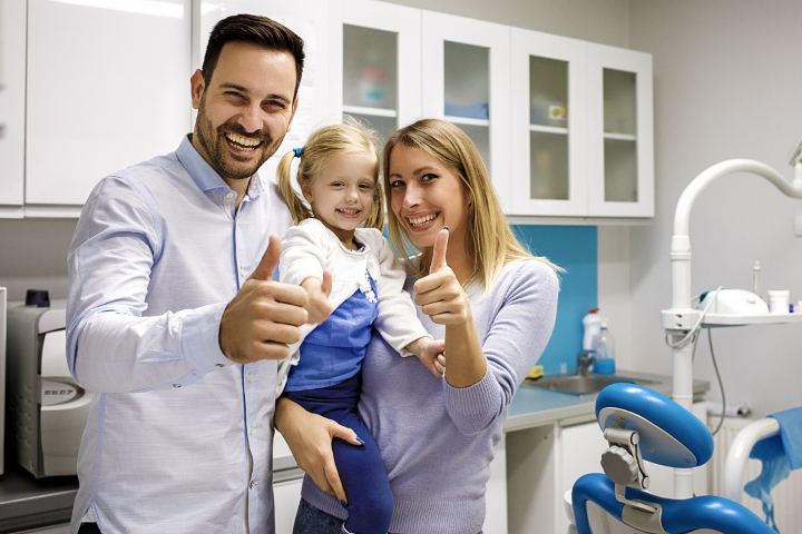 Happy family at Dr. Maria Smith's Shelton dental office receiving preventive family dentistry and routine checkups.