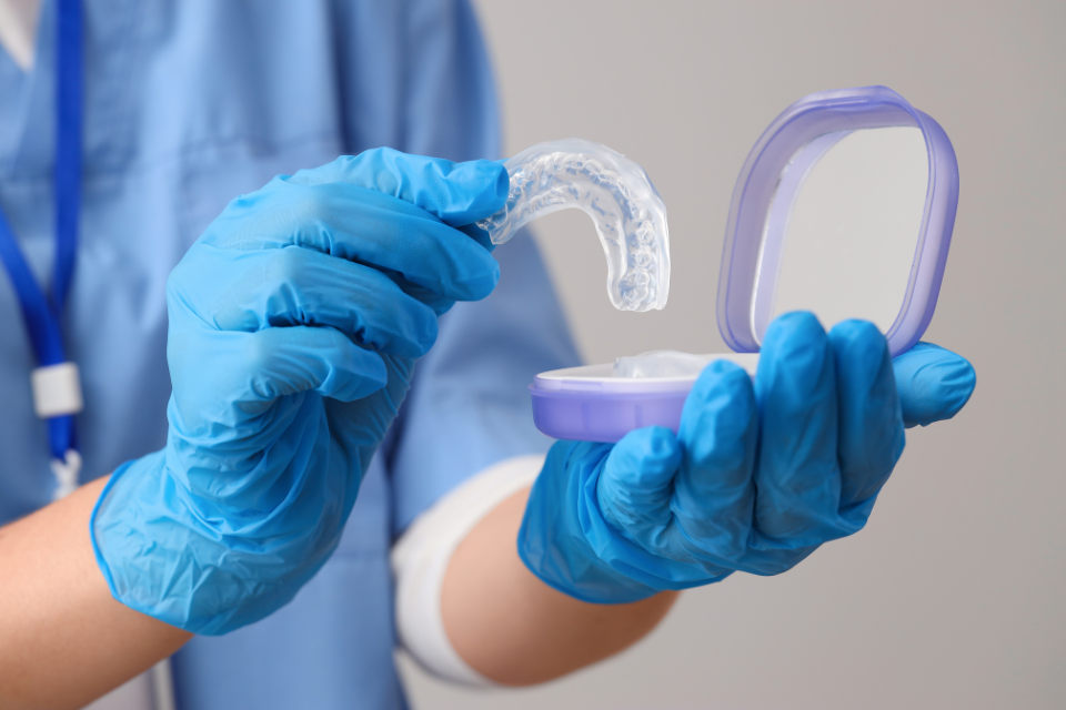 Mouthguard Detailed view of a custom porcelain inlay being prepared to restore a damaged molar tooth.