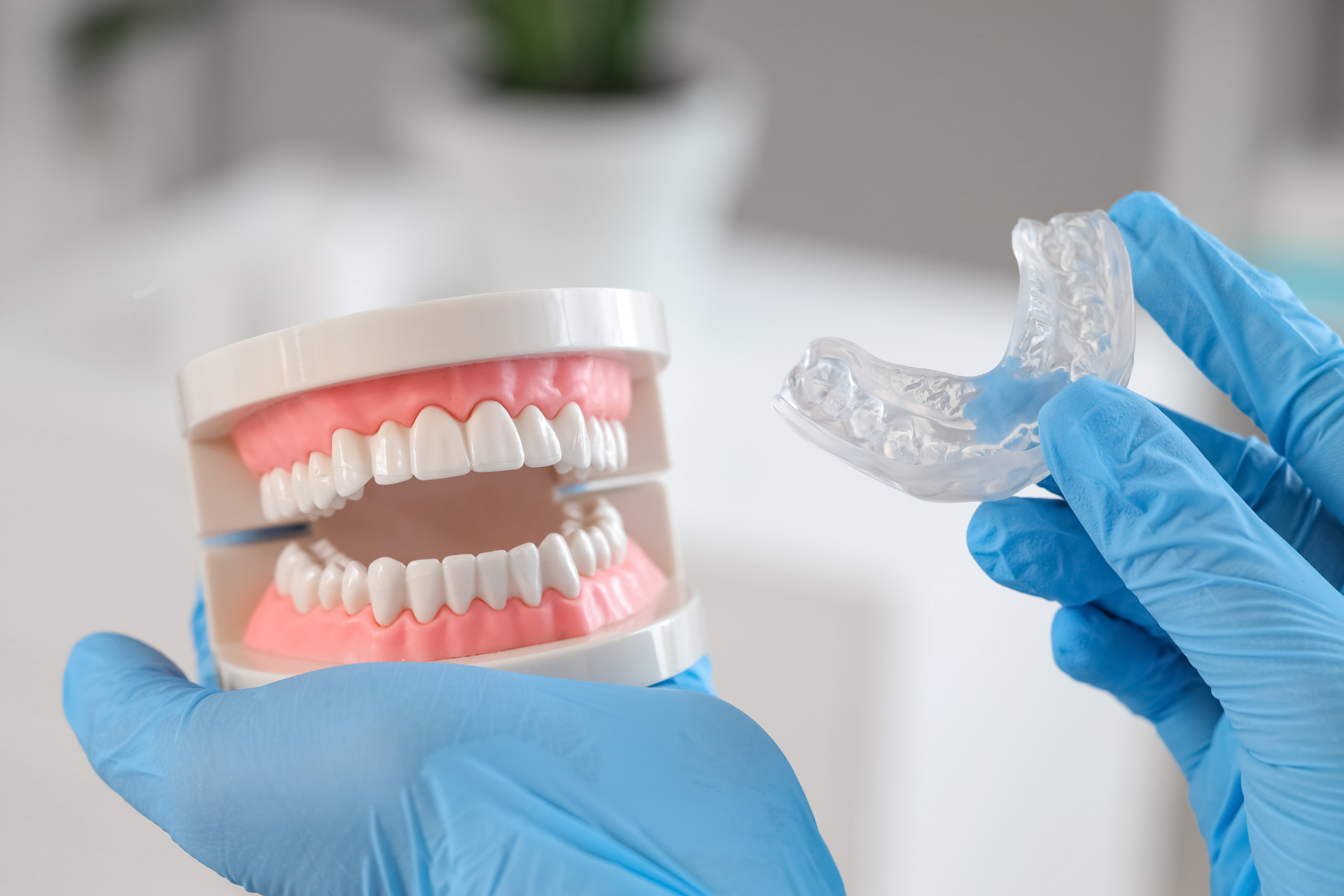 Dr. Maria Smith evaluating a patient for TMJ jaw pain with a custom-fitted occlusal guard for teeth grinding.
